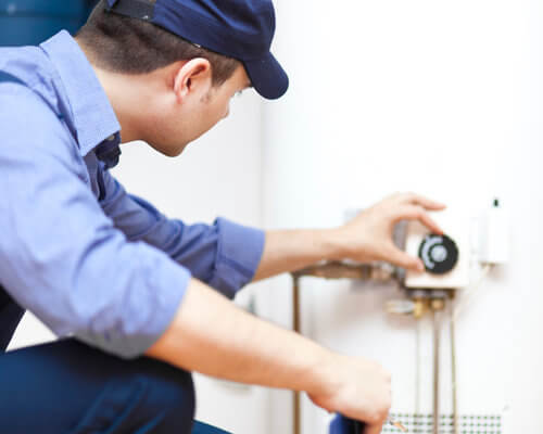 Tech Repairing Water Heater