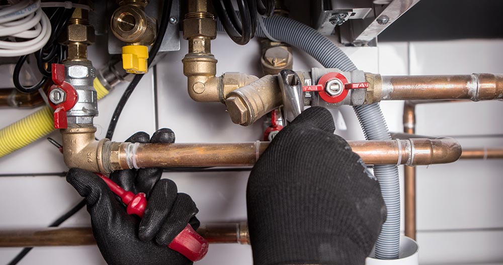 Plumber using wrench on a gas line